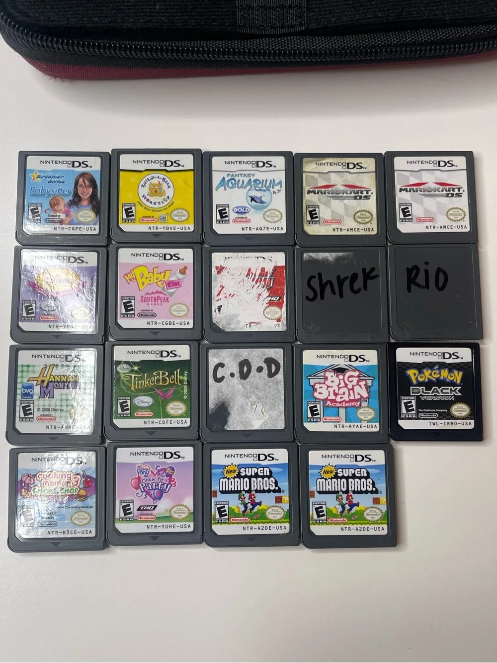 19 Nintendo DS games and Nintendo DS XL case with travel game cases and stylus